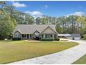 Well-maintained single-story home with attached garage, lush lawn, and mature trees at 2517 N Hightower Trl, Conyers, GA 30012