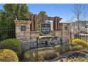 Stone sign for Saddle Brook by Century Communities, surrounded by manicured landscaping and an iron fence at 2537 Oak Barrel Dr, Snellville, GA 30078