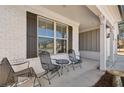 Cozy front porch with seating area featuring metal chairs and a small table, perfect for relaxing outdoors at 2537 Oak Barrel Dr, Snellville, GA 30078
