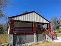 Charming home with a front porch, modern siding, and stone accents on the foundation at 624 S Grand Nw Ave, Atlanta, GA 30318