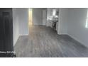 Bright living room featuring modern gray vinyl floors and fresh paint at 624 S Grand Nw Ave, Atlanta, GA 30318