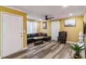 A cozy living room is showcased, with hardwood style floors, a comfortable leather couch, and a ceiling fan at 660 Simmons St, Atlanta, GA 30318