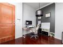 Office area with door, hardwood floors, built-in shelving, and modern lighting at 3040 Peachtree Nw Rd # 1509, Atlanta, GA 30305