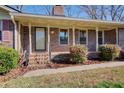 Welcoming brick porch with elegant railing and lush landscaping at 5010 Highway 20 Ne, Conyers, GA 30012