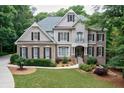 Charming two-story home with a beautifully landscaped front yard and classic architectural details at 5053 Chapel Xing, Douglasville, GA 30135