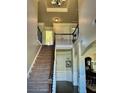 Open entryway featuring wood stairs with iron railing and decorative trim at 611 Winners Cir, Locust Grove, GA 30248