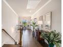 Upstairs hallway features wood floors, elegant decor, natural light, and staircase to the lower level at 1604 Falcon Ct, Locust Grove, GA 30248