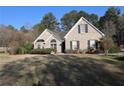 Beautifully landscaped front yard with mature trees, offering shade and curb appeal to this inviting home at 1313 Idlewood Ct, Mcdonough, GA 30252