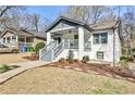 Attractive bungalow with covered porch and tidy landscaping on a sunny day at 17 Bates Se Ave, Atlanta, GA 30317