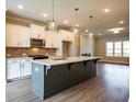 Open concept kitchen boasts a large island with bar seating, pendant lights, and modern finishes at 1923 Deco Dr, Kennesaw, GA 30144