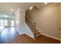 Staircase has wood stairs, white risers, and a black metal decorative banister and stained handrail at 1923 Deco Dr, Kennesaw, GA 30144