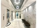 Hallway with elevators, textured wall, and recessed lighting in a modern building at 325 E Paces Ferry Ne Rd # 1606, Atlanta, GA 30305