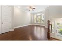 Spacious living room with dark hardwood floors, large windows, and a ceiling fan at 513 Broadview Ln, Atlanta, GA 30324