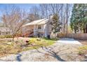 Exterior view showing backyard with a pond, stream, and outdoor parking pad at 3016 Ansley Manor Ct, Snellville, GA 30078