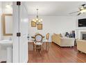 Open-concept living and dining area with hardwood floors, fireplace, and plenty of seating at 5711 Keys Way, Lithonia, GA 30058