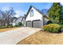 Two-car garage, with clean driveway, white exterior, green bushes, and lawn at 1230 Newbridge Ne Trce, Brookhaven, GA 30319