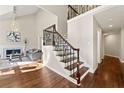 Bright living room with fireplace, hardwood floors, staircase with iron railing, and high ceilings for an airy feel at 1230 Newbridge Ne Trce, Brookhaven, GA 30319