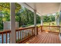 Inviting covered front porch with wood flooring and railing, perfect for enjoying the outdoors at 1321 Bridges Sw Ave, Atlanta, GA 30310