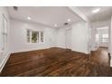 Bright living room features hardwood floors, white walls, and a front door at 2584 Oldknow Sw Dr, Atlanta, GA 30318