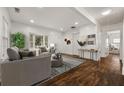 Bright living room featuring hardwood floors, a bay window, and stylish decor at 2584 Oldknow Sw Dr, Atlanta, GA 30318