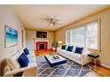 Bright living room with hardwood floors, ceiling fan, fireplace, and an area rug, all complemented by an abundance of natural light at 32 Hillcrest Se Dr, Austell, GA 30168