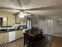 Cozy kitchen with a dining area, featuring modern appliances and ample cabinet space, with a door to the back at 4536 Amy Rd, Snellville, GA 30039