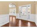 Inviting foyer featuring dark wood floors, decorative molding, and an abundance of natural light at 3070 Staglin Dr, Powder Springs, GA 30127
