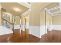Spacious living room boasting elegant columns, wainscoting, and gleaming hardwood floors at 3070 Staglin Dr, Powder Springs, GA 30127