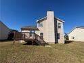 Backyard view with wood deck and stairs, and view of the back exterior elevation of the two-story home at 870 Pine Shoals Dr, Atlanta, GA 30349