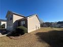 Spacious backyard and view of the side exterior elevation of the two-story home with well-maintained landscaping at 870 Pine Shoals Dr, Atlanta, GA 30349