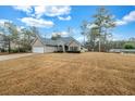 A cozy single-Gathering home featuring a spacious front yard, attached garage, and classic design elements at 2327 Maple Ave, Morrow, GA 30260