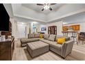 Spacious living room with a comfortable sectional, open to kitchen, and modern decor at 2327 Maple Ave, Morrow, GA 30260