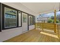 Covered front porch with wooden flooring and a decorative yellow horizontal slat railing at 2494 Baxter Rd, Atlanta, GA 30315