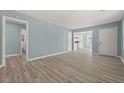 Bright, open-concept living room with modern floors and fresh blue walls with views to the kitchen and bathroom at 2494 Baxter Rd, Atlanta, GA 30315
