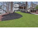 Beautiful home nestled amongst trees with a green lawn at 2497 Wawona Ne Dr, Brookhaven, GA 30319