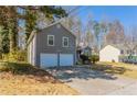 Side view of a charming home, highlighting its architectural details and garage at 6265 Stoney Cv, Austell, GA 30168