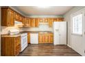 Bright kitchen featuring wooden cabinets, modern appliances, and hardwood floors at 6265 Stoney Cv, Austell, GA 30168