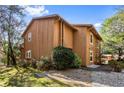 Side view of a brown two-story home with a well-maintained lawn and gravel pathway, showcasing its architectural design at 838 Lake Hollow Sw Blvd, Marietta, GA 30064