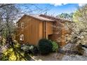 Charming two-story home with a vertical wood plank exterior and mature trees around it at 838 Lake Hollow Sw Blvd, Marietta, GA 30064