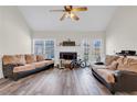 Inviting living room with vaulted ceilings, fireplace, and French doors to create a spacious atmosphere at 114 N Springs Way, Acworth, GA 30101