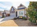 Beautiful home exterior featuring manicured landscaping and a cozy bench near the entrance at 307 Serenity Way, Woodstock, GA 30188