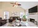 Cozy living room with a white fireplace, brown leather furniture, and vaulted ceilings at 740 Helga Ne Dr, Woodstock, GA 30188