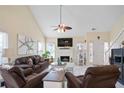 Cozy living room with a fireplace, high ceilings, and ample natural light from many windows at 740 Helga Ne Dr, Woodstock, GA 30188