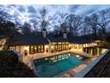 Backyard oasis with a sparkling in-ground pool, patio area, and lush landscaping perfect for relaxation at 3565 Haddon Hall Nw Rd, Atlanta, GA 30327