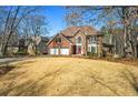 Charming two-story brick home with a spacious front yard, two-car garage, and a welcoming entrance at 724 Laurel Chase Sw, Marietta, GA 30064