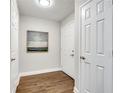 Entry hallway with hardwood flooring, neutral paint, and multiple white paneled doors at 1074 Peachtree Ne Walk # B306, Atlanta, GA 30309