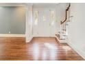 Bright foyer with hardwood floors, a stained glass front door, and staircase with wooden railing at 1883 Acuba Ln, Atlanta, GA 30345