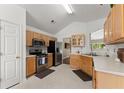 Well-lit kitchen with stainless steel appliances, light wood cabinets, and a view to the breakfast area at 2405 Landrum Ct, Lawrenceville, GA 30043