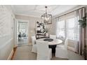 Elegant dining room featuring stylish lighting, neutral decor, and ample seating at 1848 Flagler Ne Ave, Atlanta, GA 30309