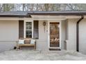 Inviting front porch with a cozy bench and decorative pillows, perfect for relaxation at 2031 Audubon Ne Dr, Atlanta, GA 30329